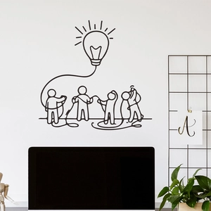 Creative black light bulb wall sticker with stick figures on an office wall