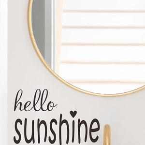 Hello Sunshine wall sticker with heart design on a gold framed round mirror