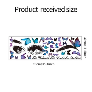 Detail of DIY wall sticker featuring eye lashes, butterflies and motivational quotes