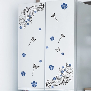 Detail showing blue flowers and butterfly wall stickers on a white refrigerator surface