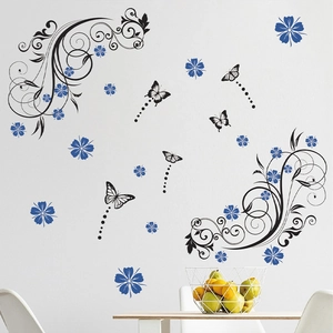 Elegant floral wall decal with black vines, blue flowers, and butterflies on a white wall