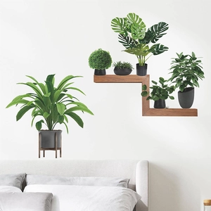 Fresh monstera and potted greenery wall stickers decor on a white wall above a bed