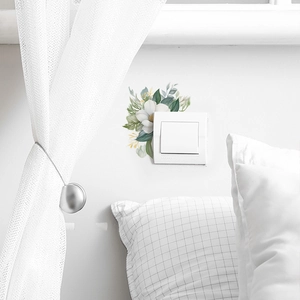 Elegant floral light switch wall decal with white petals and green leaves for home decor