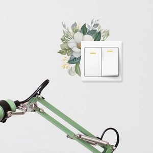 Detail showing hand-painted green leaves and white flowers sticker around light switch
