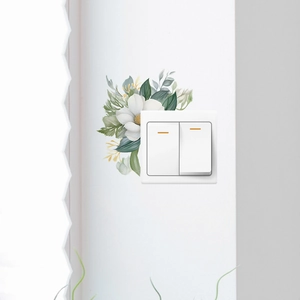 Watercolour floral light switch sticker with white flowers and green leaves on wall