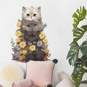Detail view of cute cartoon stacked cats wall sticker in a cozy nursery room setting