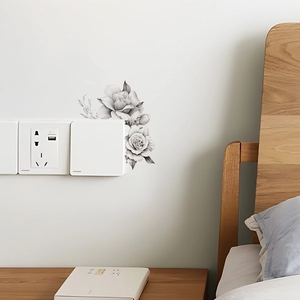Detailed sketch of black and white rose wall sticker placed above a light switch