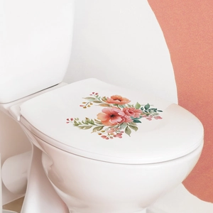 Close-up of pink floral and green leaf wall stickers on a white ceramic toilet lid