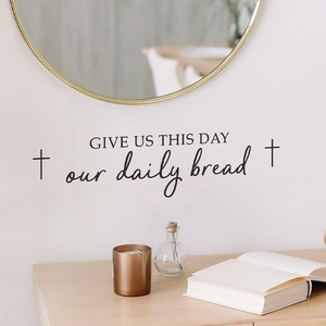 Religious 'Give us this day our daily bread' wall sticker with cross icons on white wall