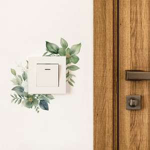 Watercolour green leaf and floral wall stickers decorating a white light switch panel