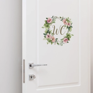 Detailed view of a watercolor floral WC door sticker on a white interior door with handle