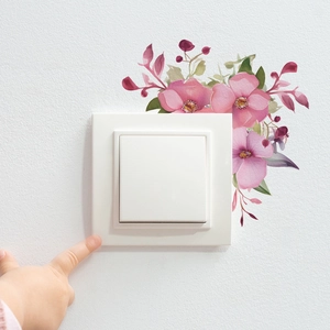 Close-up of pink watercolor morning glory flower stickers around a wall light switch