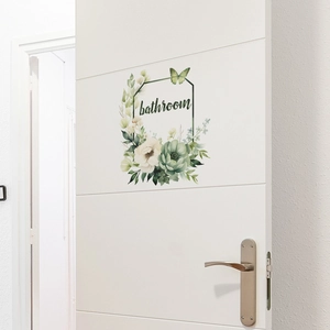 Macro detail of floral hexagonal bathroom wall decal on a white wooden door