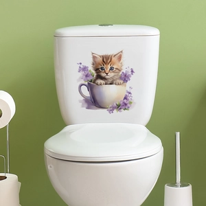 Detailed view of a cute cartoon cat in a cup sticker on a white ceramic toilet tank