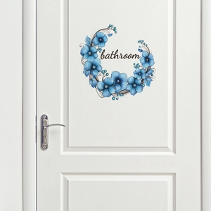 Close-up of blue floral bathroom door sticker with elegant script lettering