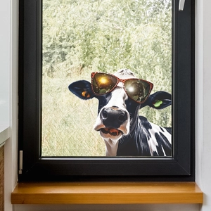 Funny cow window sticker with leopard print sunglasses on a glass window frame