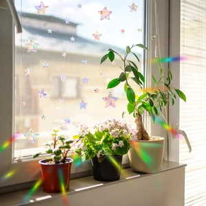 Rainbow prism star window film stickers creating colorful light refraction on glass