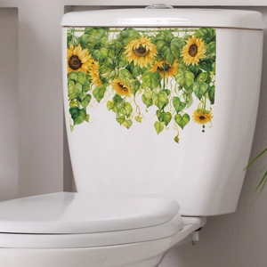 Detail of vibrant sunflower and green leaf decals on a white bathroom toilet tank