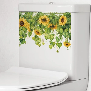 Sunflower and green leaves decorative wall sticker on a white ceramic toilet tank