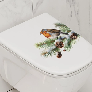 Detail of bird and snowy pine cone decal on a white modern bathroom toilet seat cover