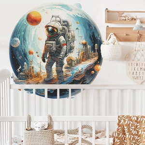 Space themed wall decal featuring an astronaut and nebula above a white crib in a nursery