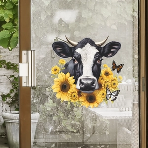 Détail d'autocollant de vache et tournesol coloré sur une porte coulissante en verre