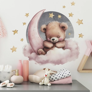 Detail of cartoon bear sleeping on pink moon wall decal with golden stars for nursery room