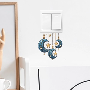 Minimalist wall sticker with gold stars and blue crescent moons near a white light switch