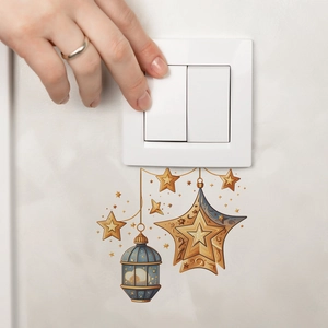 Detailed view of DIY Ramadan star and lantern wall decals applied around a light switch