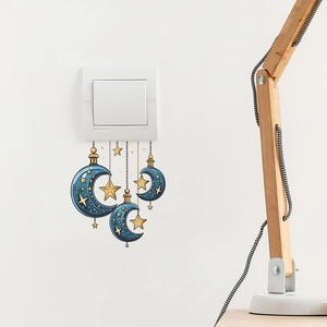Blue crescent moon and gold star wall stickers applied near a white light switch
