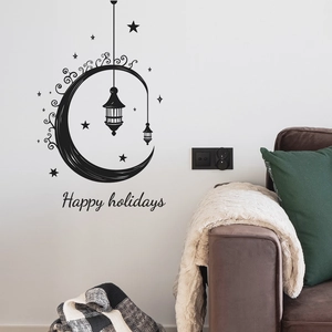 Detail of moon and lantern wall stickers with Happy Holidays text in living room decor
