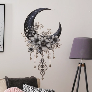 Detail of bohemian black moon wall decal with silver flowers and hanging metal pendants