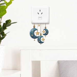 Self-adhesive moon and star wall stickers for home decor above a light switch