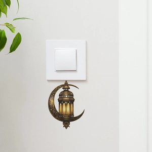 Golden moon and lantern wall sticker applied under a light switch for room decor