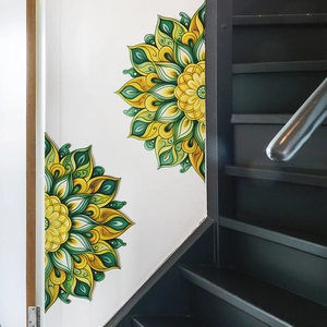 Green and yellow mandala wall decal stickers on a white staircase wall for home decor