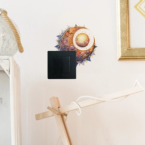 Detail of creative sun and moon mandala switch sticker on a white wall light switch