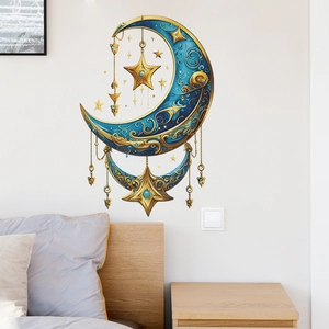 Blue and gold moon and star wall decals displayed above a bed in a modern bedroom