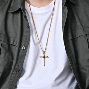 Men's gold stainless steel cross necklace with X-wrap detail and round box chain on model