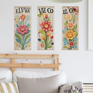 Three-piece 3D floral wall art set with pink and yellow flowers over a wooden headboard