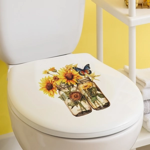 Detail of sunflower and butterfly decal applied on a white toilet lid in a bright bathroom