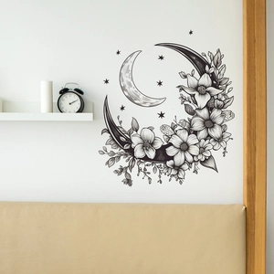 Detailed wall decal featuring a black and white moon with floral vine art on a bedroom wall