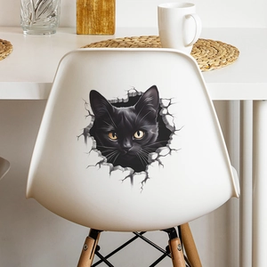 3D black cat breaking wall sticker for home decor shown on a white chair backrest