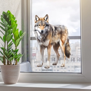 Realistic gray wolf window sticker applied on a bright glass pane with green plants