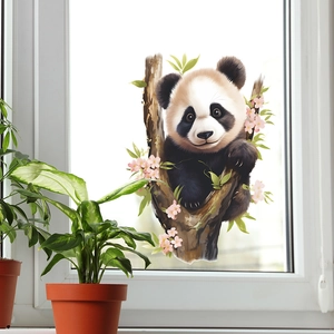Vue détaillée d'un autocollant de panda et fleurs de cerisier sur une fenêtre en verre