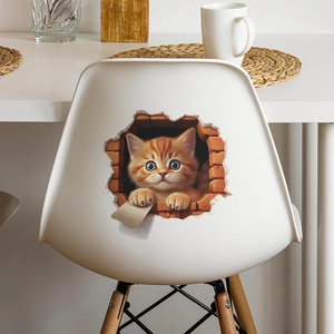 Detailed view of 3D orange cat wall sticker applied on a white chair backrest