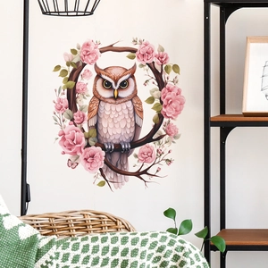 Detail of owl wall decal sitting on a circular branch wreath with pink rose floral accents