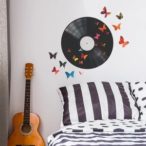 Close-up of 3D colorful butterfly wall stickers around a vintage vinyl record decor