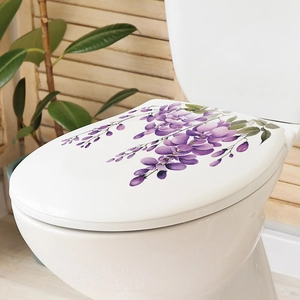 Detailed view of purple wisteria floral decals on white toilet lid in a bathroom
