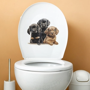 Cute cartoon puppy trio toilet seat stickers featuring black and yellow labs on white lid