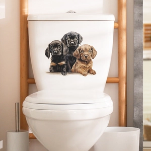 Three cute puppy bathroom wall stickers on a white toilet tank in a warm home setting